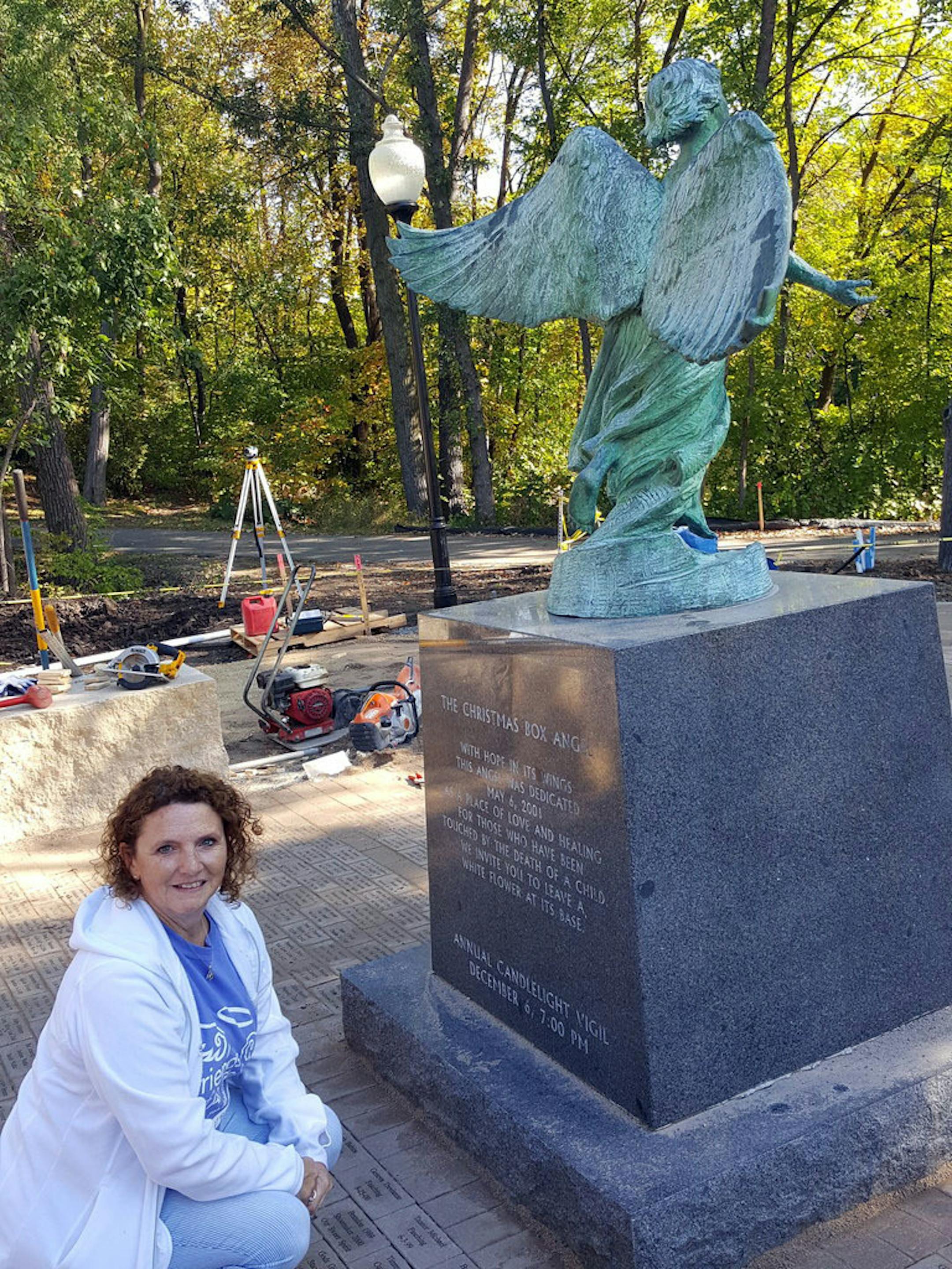 Sue Drag, president of nonprofit the Friends of the Angel, inspects the renovation work happening at the Angel of Hope Garden at the Maple Grove Arboretum.