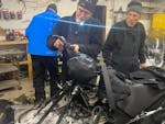 Paul Dick, 72, Rob Hallstrom, 65, and Rex Hibbert, 70 , repair one of their snowmobiles in Fort Yukon, Alaska.