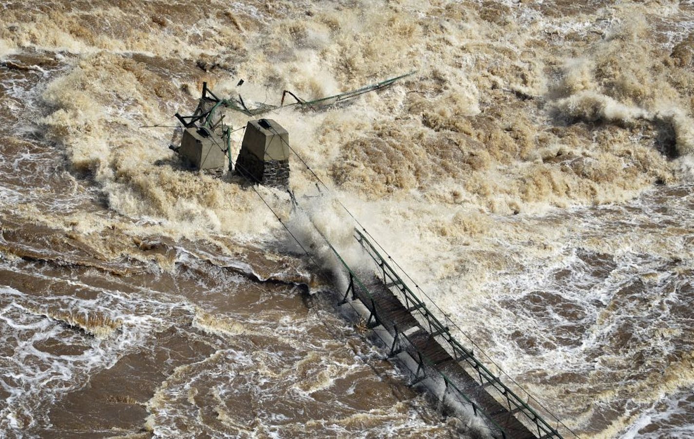 The St. Louis River raged out of control in June. Among the damage done in northeastern Minnesota was the wiped-out swinging bridge in Jay Cooke State Park.