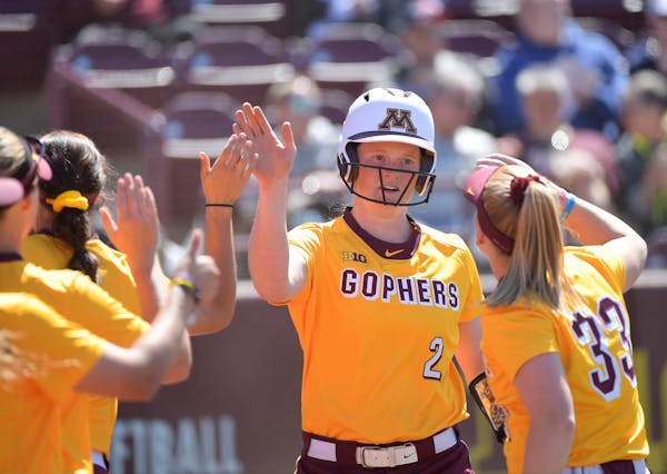 Minnesota's Dani Wagner (2) celebrated with teammates after scoring a run against Wisconsin last month.
