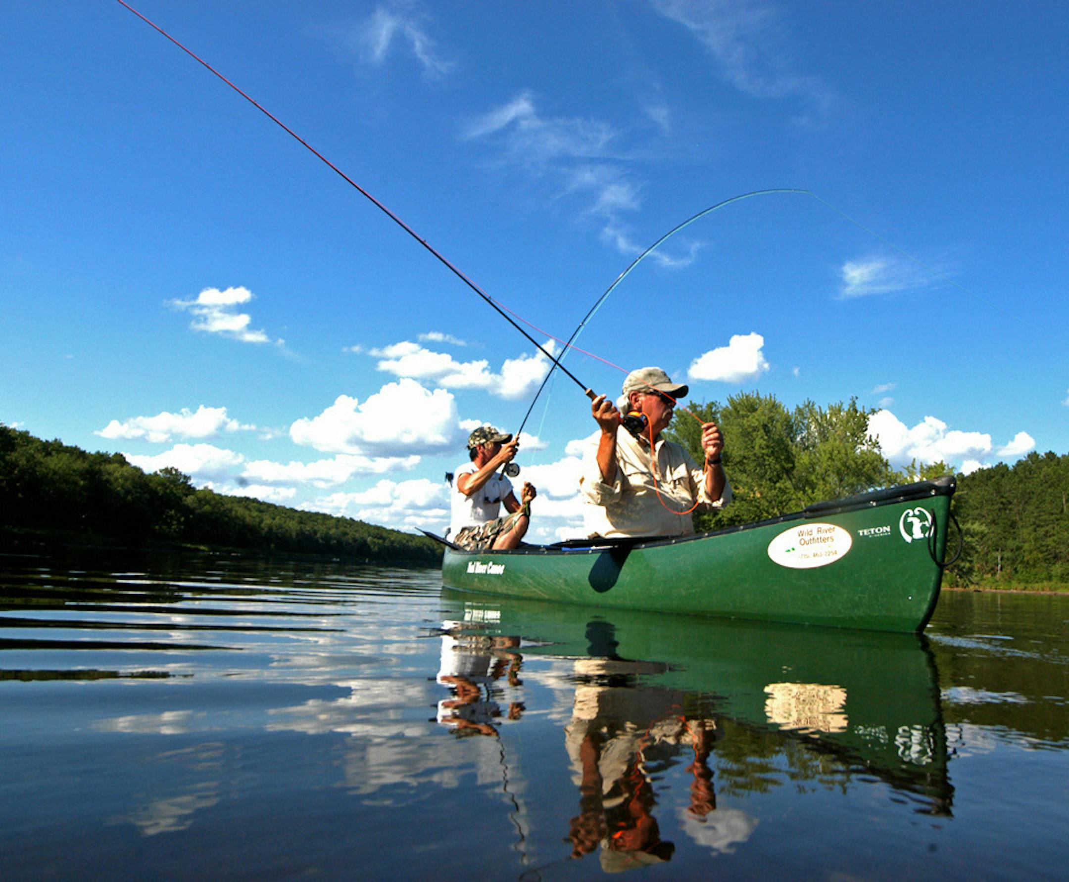 PASSING ON KNOWLEDGE: Fly casting expert and instructor Bob Nasby of St. Paul, in the canoe bow , has taught countless young people how to cast and how to fly fish, including grandson Bobby McGraw, in the stern. ORG XMIT: MIN2013112206313606