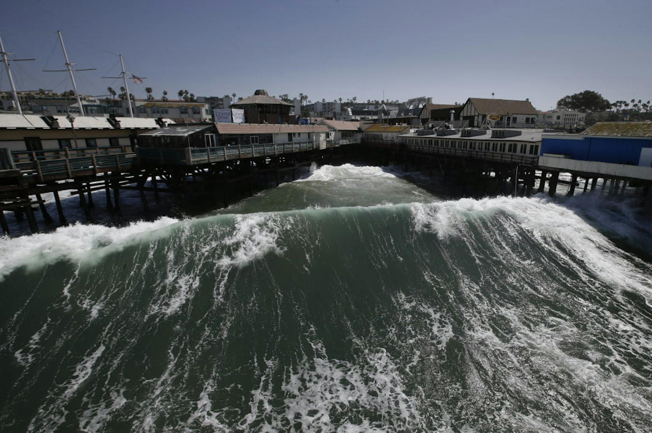 Waves hit the Redondo Beach Pier in Redondo Beach, Calif., Monday.