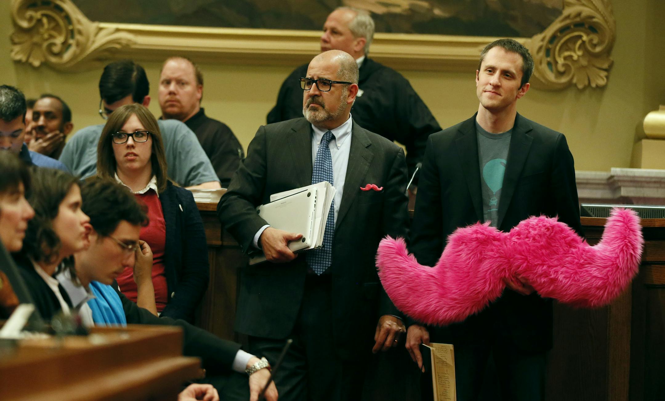 Matthew Johnson right waited his turn to speak at a public hearing at Minneapolis City council chambers on Tuesday. Taxi drivers and supporters of app-based transportation companies testified on a bill that would legalize services like Lyft and Uber to the Minneapolis city council Tuesday April 29, 2014 in Minneapolis, MN. ] Jerry Holt Jerry.holt@startribune.com
