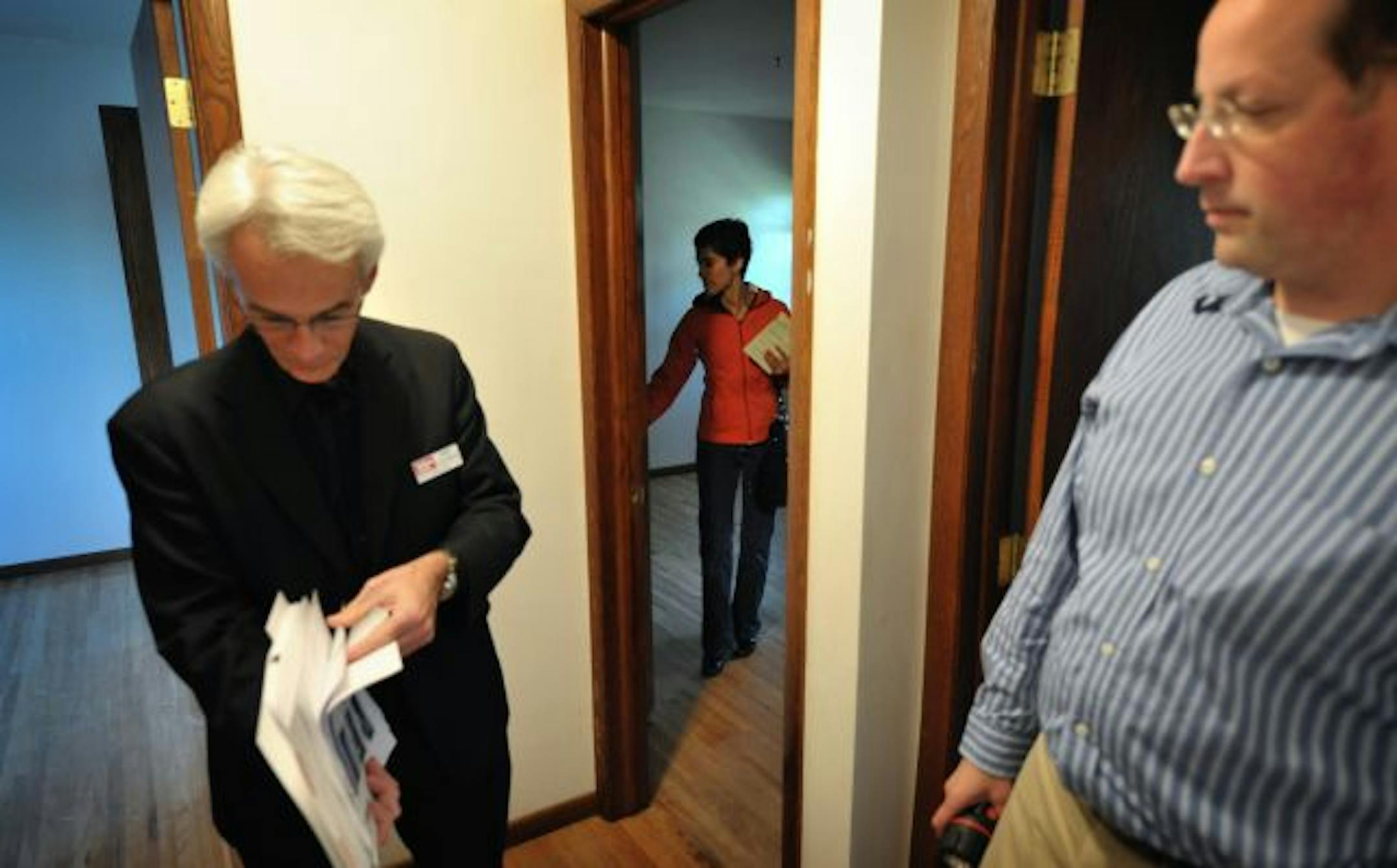 First time home buyers Rick Raihle and his wife Ruth Baires Raihle, right, looked at a home in Apple Valley with the help of realtor Jeff Cauble, left.