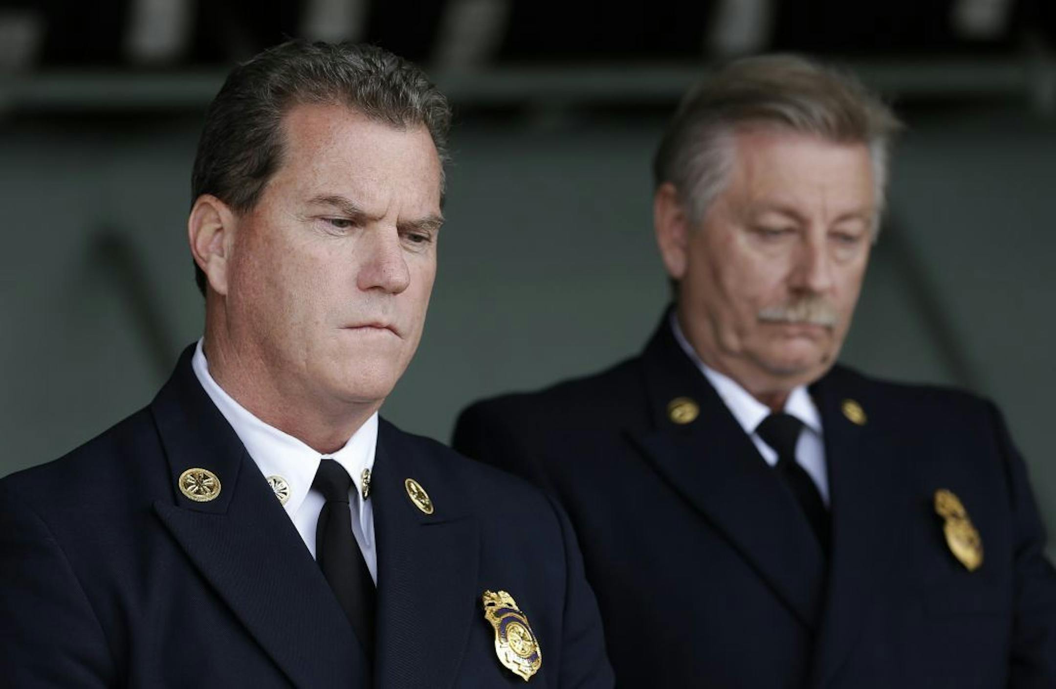 Foster City Fire Department Chief Michael Keefe, left, and Foster City Fire Investigator John Mapes listen to speakers at a news conference at the California Highway Patrol headquarters in Redwood City, Calif., Monday, May 6, 2013. Investigators are trying to determine why the back of a stretch limousine burst into flames on a San Francisco Bay bridge, trapping and killing five of the nine women inside.