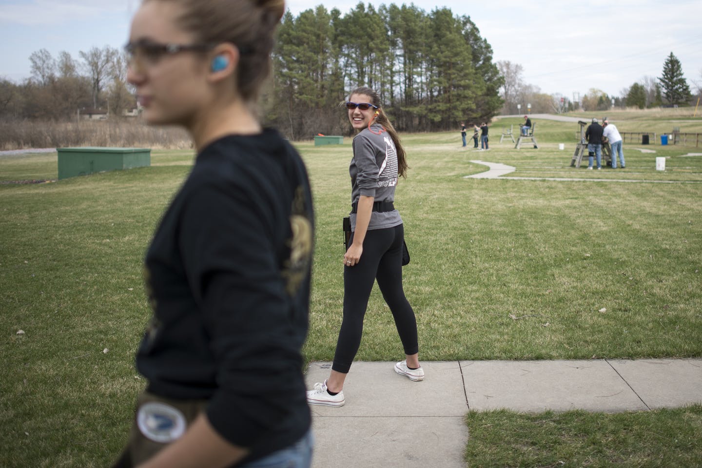 Stephanie Petsilis, center, a junior at Wayzata, jokes with her teammates between practice rounds on Thursday afternoon. ] (Aaron Lavinsky | StarTribune) aaron.lavinsky@startribune.com Photos to accompany an Outdoors Weekend story about the wild popularity of high school trapshooting teams in Minnesota. The Wayzata clay target league team was photographed on Thursday, April 16, 2015 at the Park Sportsmens Club in Wayzata.