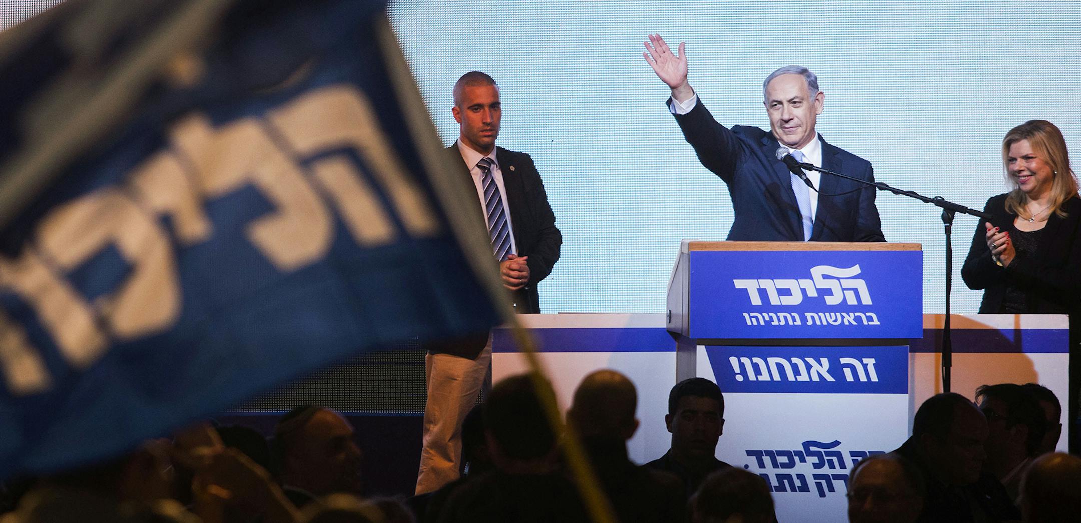 Israeli Prime Minister Benjamin Netanyahu greets supporters at the party's election headquarters In Tel Aviv. Wednesday, March 18, 2015. Exit polls from Israelís national elections showed Prime Minister Benjamin Netanyahuís Likud party nearly deadlocked with Isaac Herzogís center-left Zionist Union. (AP Photo/Dan Balilty) ORG XMIT: MIN2015031720323384