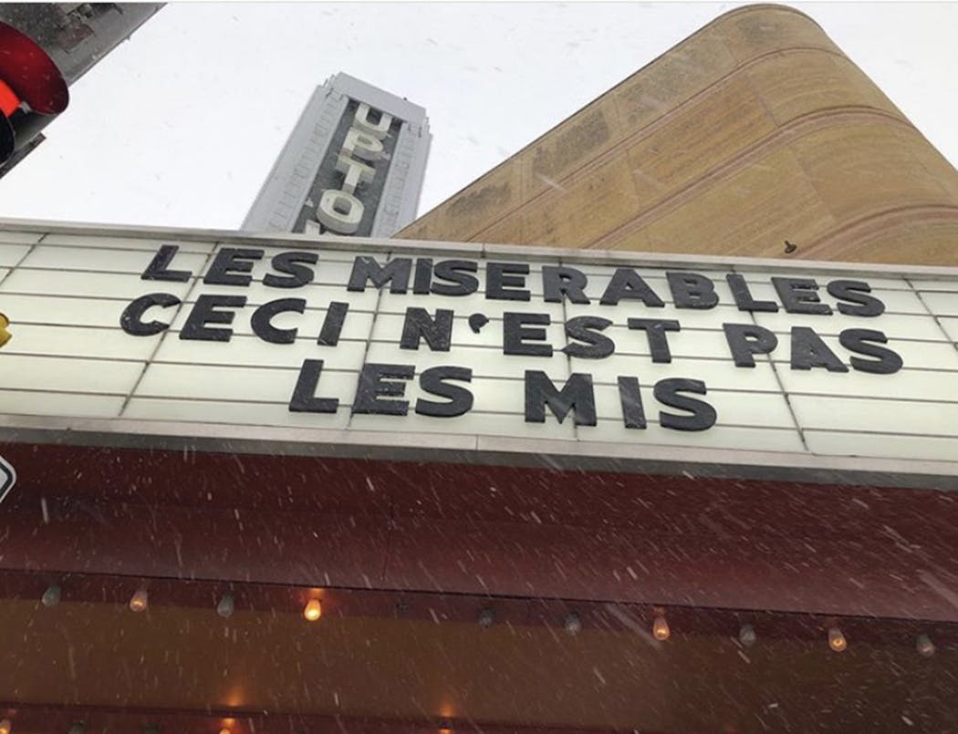 This marquee warned moviegoers that a 2019 film set in modern Paris is not the same as the beloved musical of the same name.