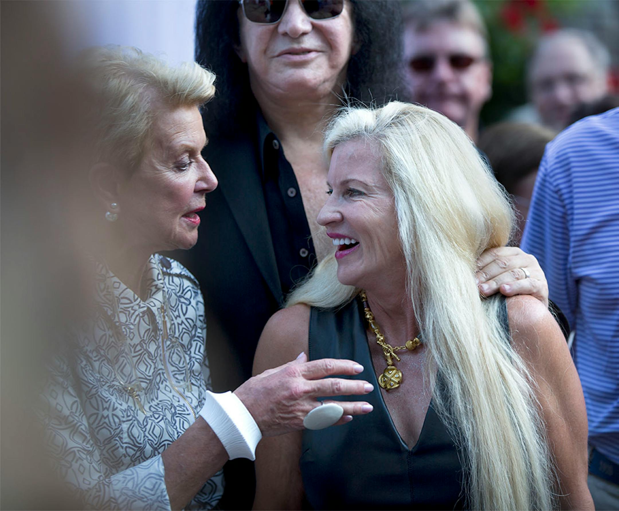 Kiss' Gene Simmons posed for pictures philanthropist Martha "Muffy" MacMillan before a charity concert at her house on Tuesday, August 2, 2016, in Long Lake, Minn.