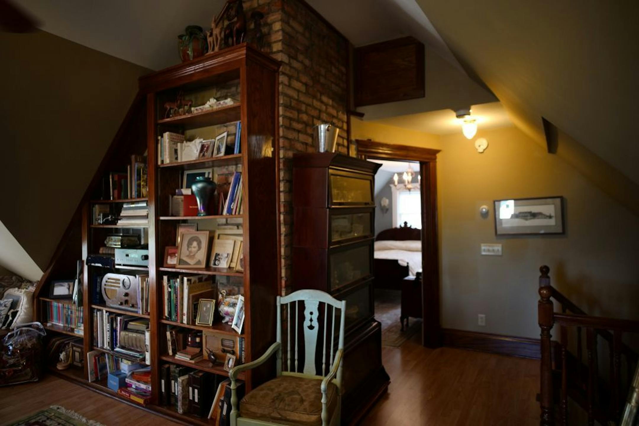 A bookcase fits under the sloped walls of Craig Pier's attic great room.