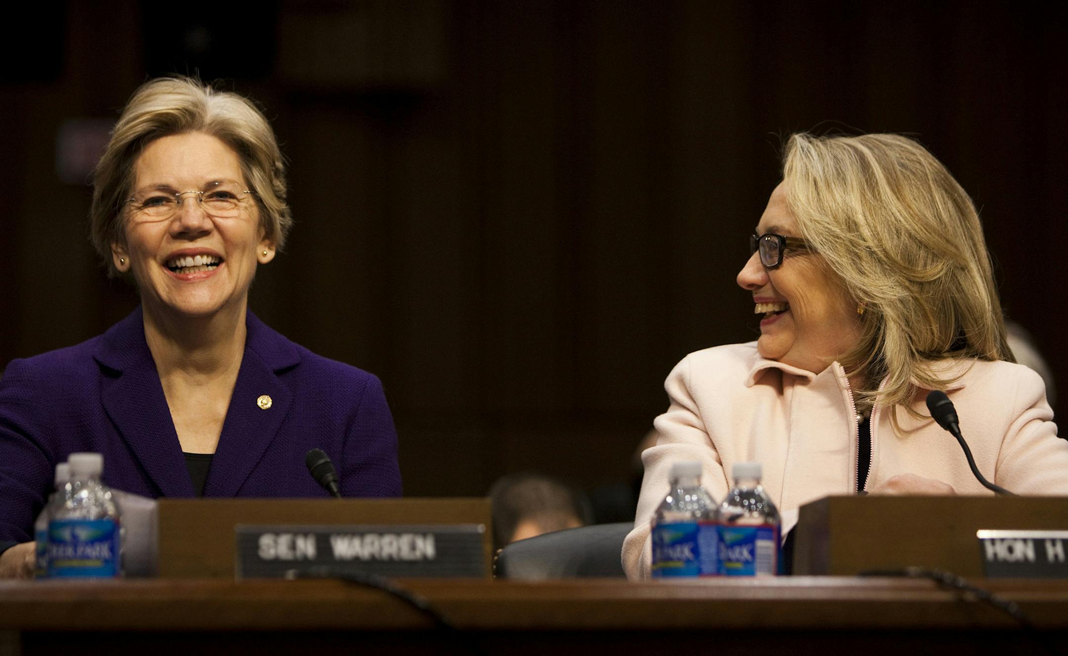 FILE-- Sen. Elizabeth Warren (D-Mass.), left, and Secretary of State Hillary Rodham Clinton at a hearing for John Kerry's confirmation as secretary of state before the Senate Committee on Foreign Relations on Capitol Hill, in Washington, Jan. 24, 2013. Clinton, now a Democratic presidential hopeful, is embracing the economic ideas trumpeted by Warren and the populist movement — that the wealthy have been benefiting disproportionately from the economy, while the middle class and the poor h