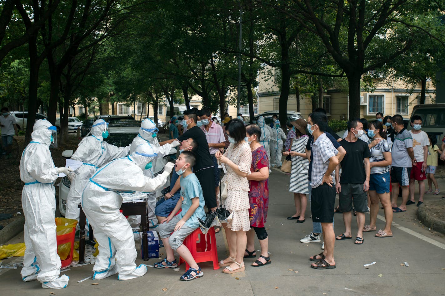 Residents line up to be tested for COVID-19 in Wuhan, central China's Hubei province Tuesday, Aug. 03, 2021. The coronavirus's delta variant is challenging China's costly strategy of isolating cities, prompting warnings that Chinese leaders who were confident they could keep the virus out of the country need a less disruptive approach. (Chinatopix via AP)