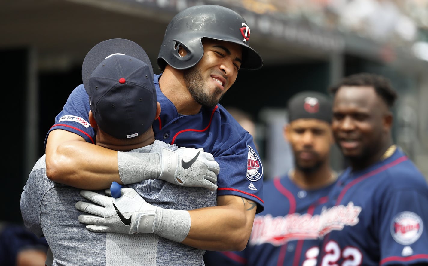 Minnesota Twins' Eddie Rosario hugs Jonathan Schoop after hitting a solo home run in the seventh inning of a baseball game against the Detroit Tigers in Detroit, Sunday, June 9, 2019. (AP Photo/Paul Sancya)