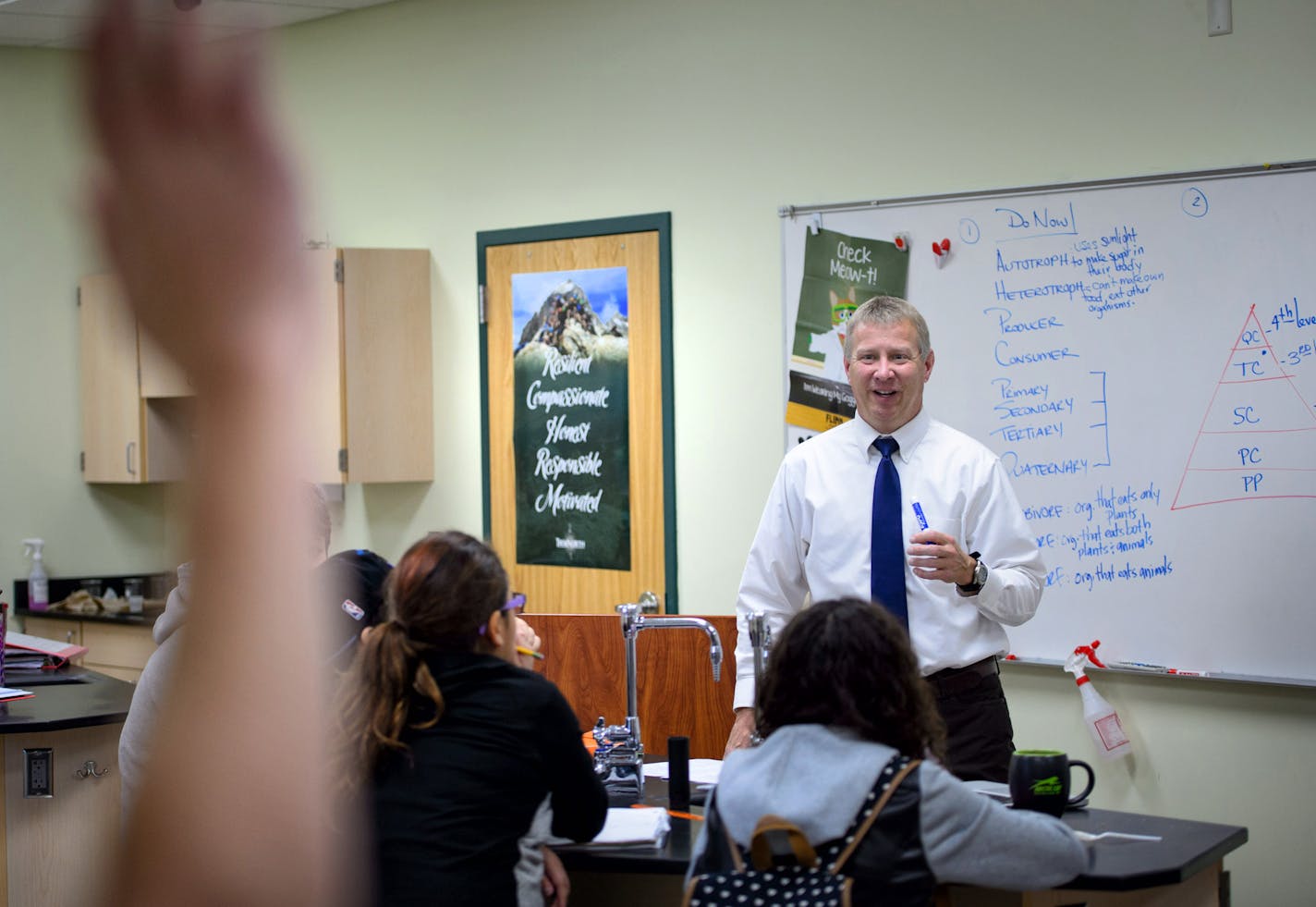 Greg Moen teaches a spirited seventh-grade life sciences class at TrekNorth. The poster in the background hangs in every classroom, the Trek Traits of Resilient, Compassionate, Honest, Responsible and Motivated.