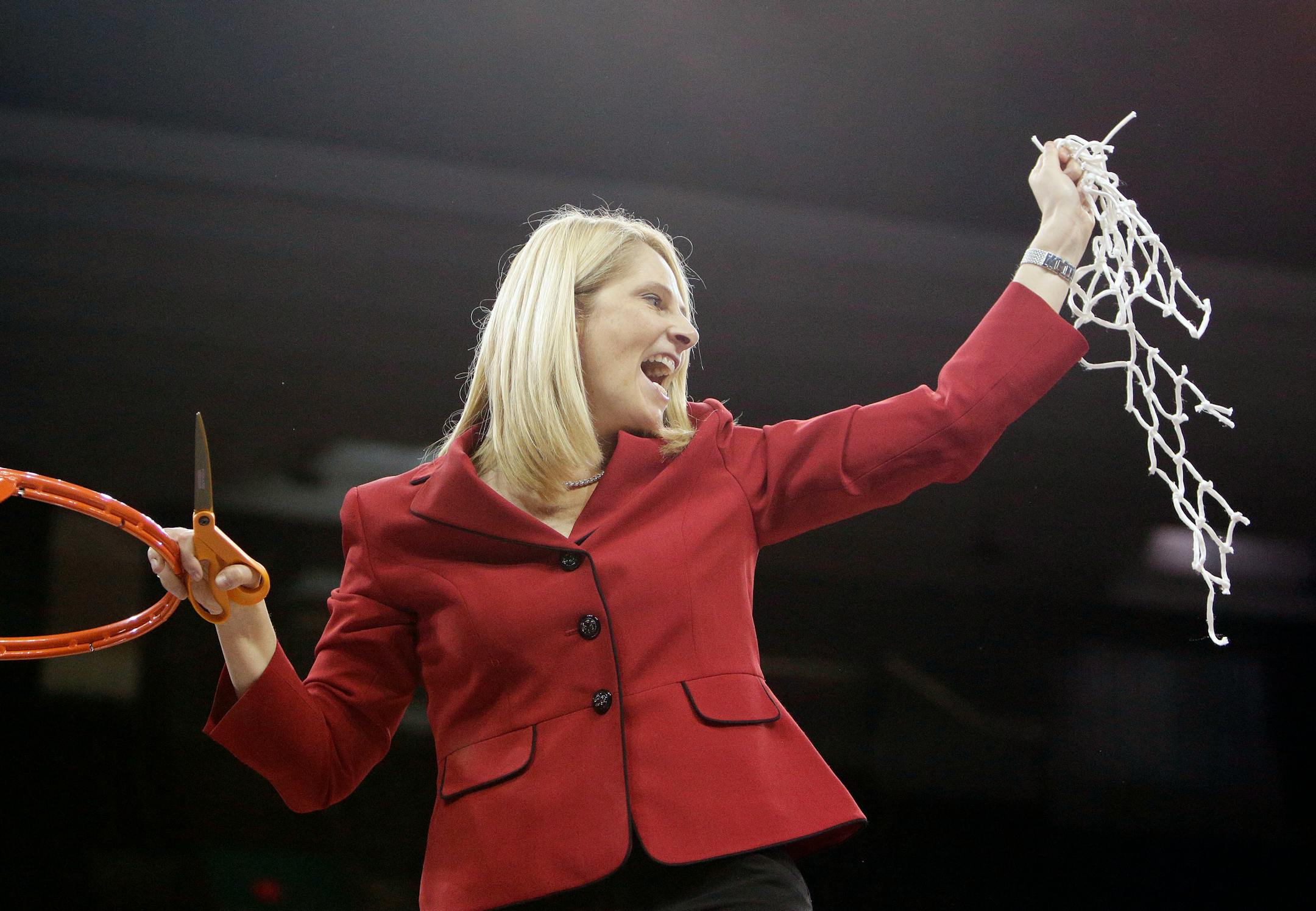 Maryland head coach Brenda Frese holds part of a net after winning a women's college basketball regional final game against Tennessee in the NCAA tournament, Monday, March 30, 2015, in Spokane, Wash. Maryland won 58-48. (AP Photo/Young Kwak)