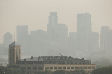 The Minneapolis skyline Monday afternoon from Ridgeway Parkway Park. JEFF WHEELER &#xef; jeff.wheeler@startribune.com Fires burning in Saskatchewan co