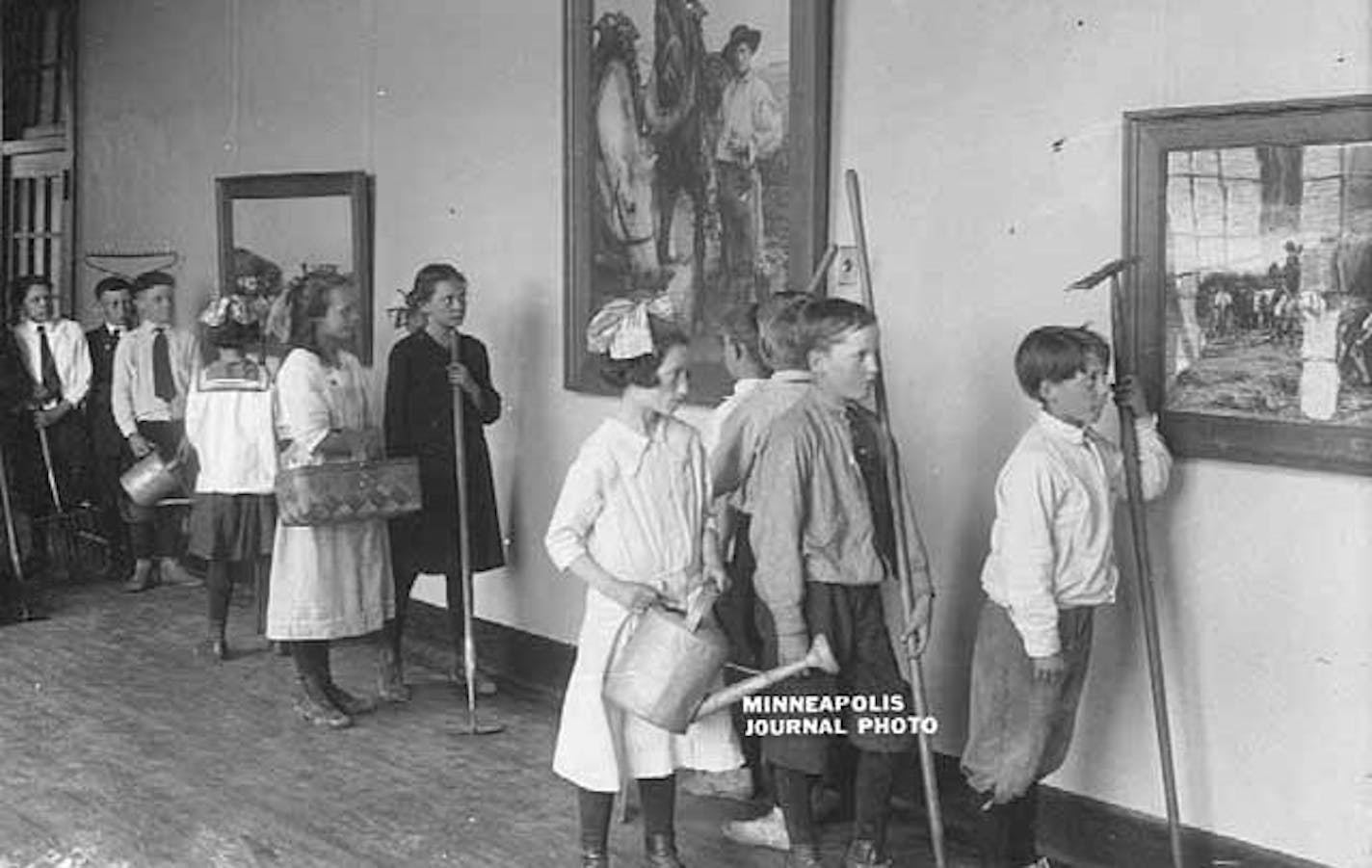 Students viewing artwork at the Thomas Lowry school in Minneapolis, shortly after the school opened in 1916.