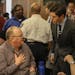 Mayor Jacob Frey chatted with Timothy J. Korsmoe (left) at the beginning of a community meeting about public safety on March 28, 2018 at the Davis Cen