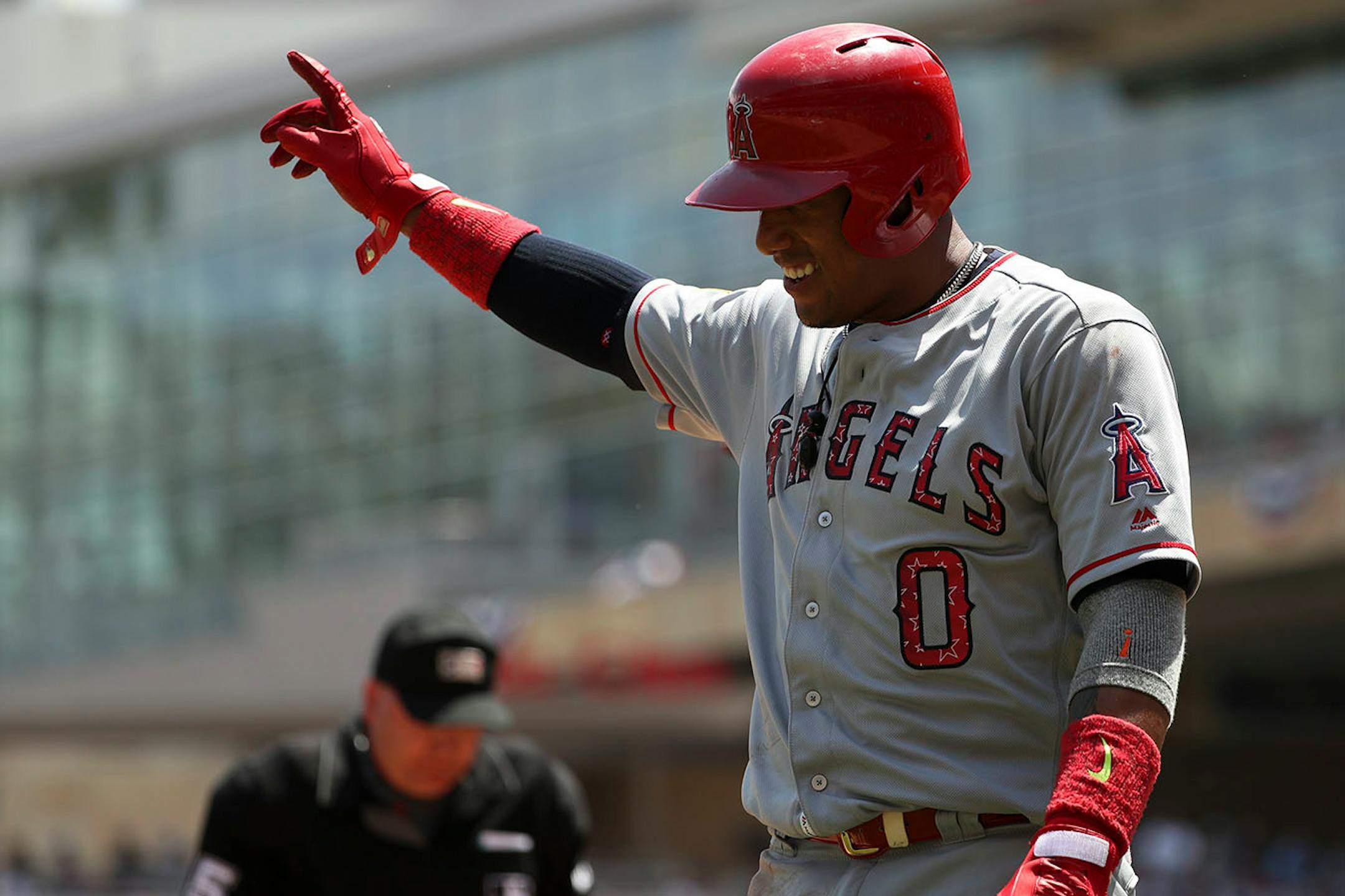Los Angeles Angels third baseman Yunel Escobar (0) celebrated after he scored past Minnesota Twins catcher Chris Gimenez (38) in the second inning.