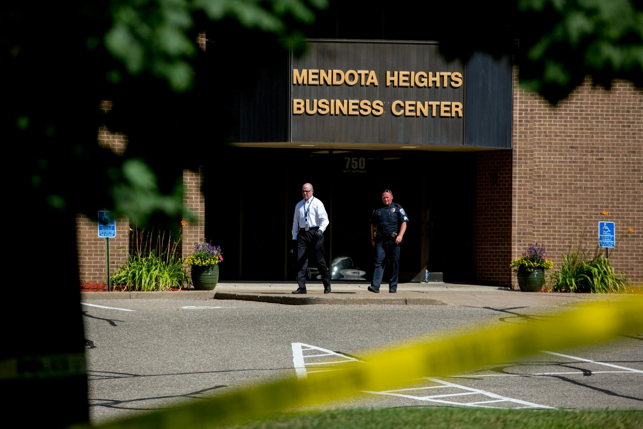 Police exit Mendota Heights Business Center following a death after an alleged armed robbery on July 29, 2017.