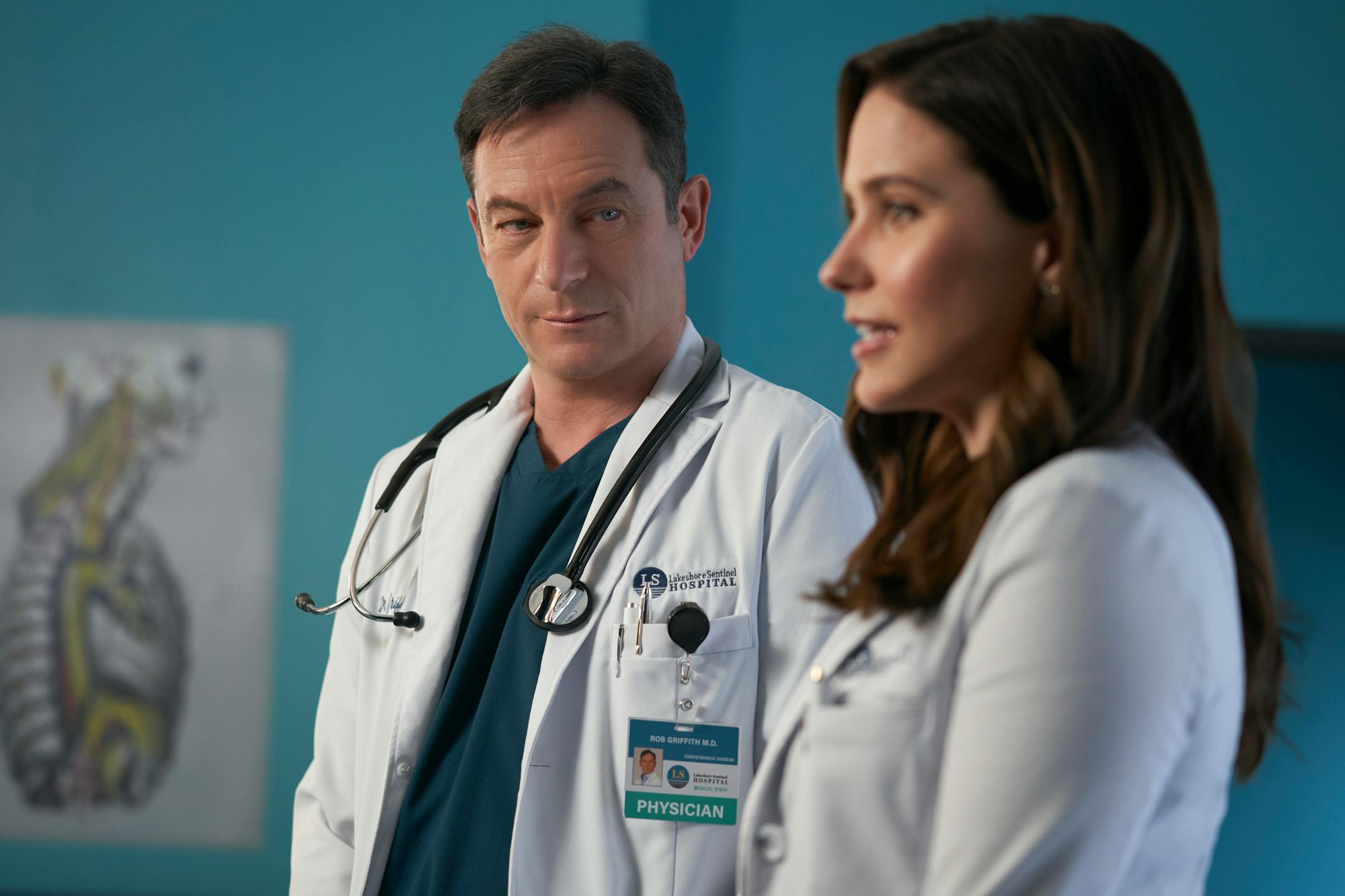"Pilot" — Sophia Bush and Jason Isaacs star in a drama about Dr. Sam Griffith, a gifted heart surgeon who excels in her new leadership role as chief of surgery after her renowned boss, Dr. Rob "Griff" Griffith, falls into a coma, on the series premiere of the CBS Original series GOOD SAM, Wednesday, Jan. 5 (10:00-11:00 PM, ET/PT) on the CBS Television Network, and available to stream live and on demand on Paramount+* Pictured L-R: Jason Isaacs as Dr. Rob \'Griff\' Griffith and Sophia Bush as Dr. Sam Griffith. Photo: Ramona Diaconescu/CBS ©2021 CBS Broadcasting, Inc. All Rights Reserved