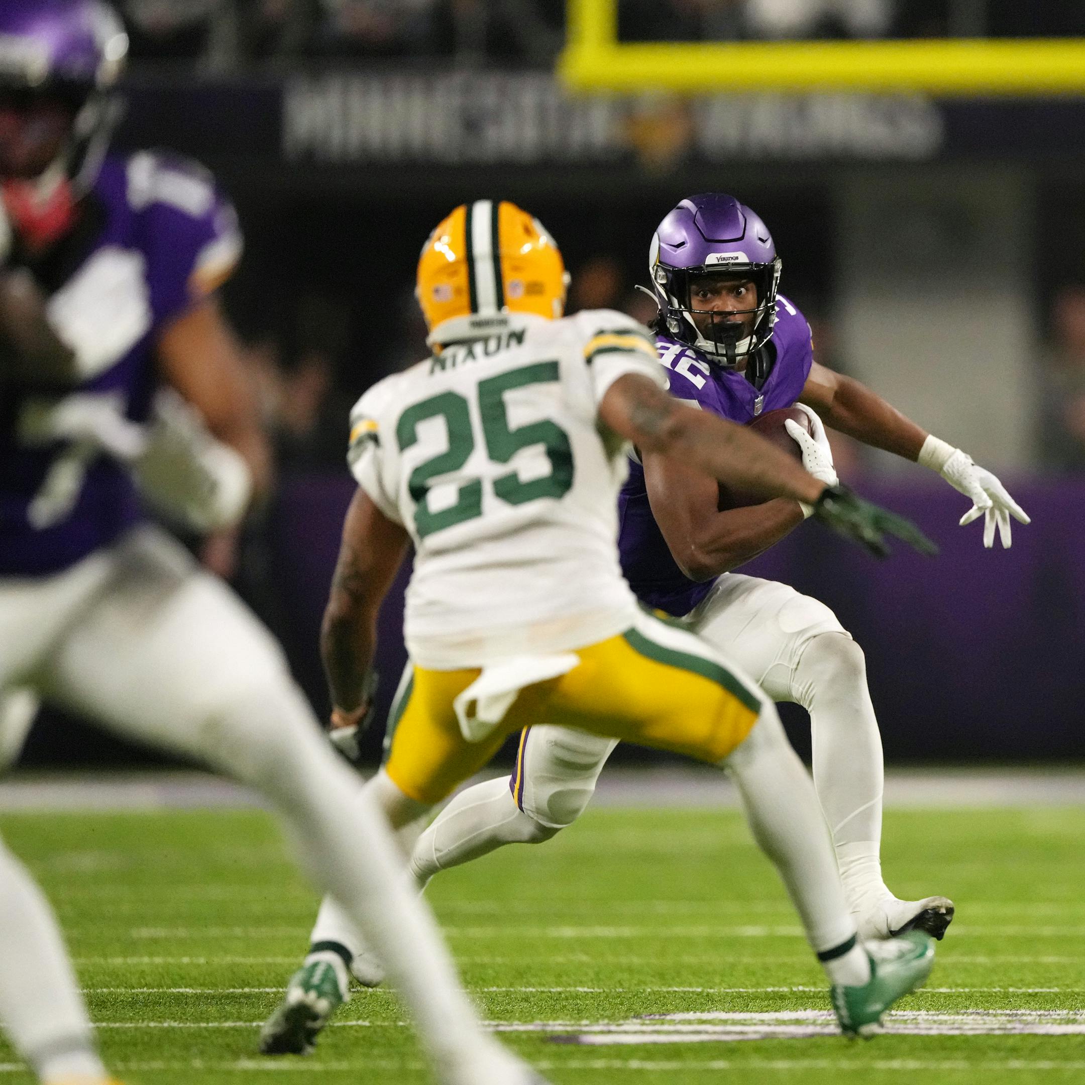 Minnesota Vikings running back Ty Chandler (32) rushes the ball as Green Bay Packers cornerback Keisean Nixon (25) looks to make the stop in the third quarter of an NFL game between the Minnesota Vikings and the Green Bay Packers Sunday, Dec. 31, 2023 at U.S. Bank Stadium in Minneapolis. ] ANTHONY SOUFFLE • anthony.souffle@startribune.com