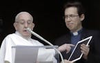 Pope Francis points at a tablet as he unveils his own user profile in Click To Pray, the official app of the Pope's Worldwide Prayer Network, during t