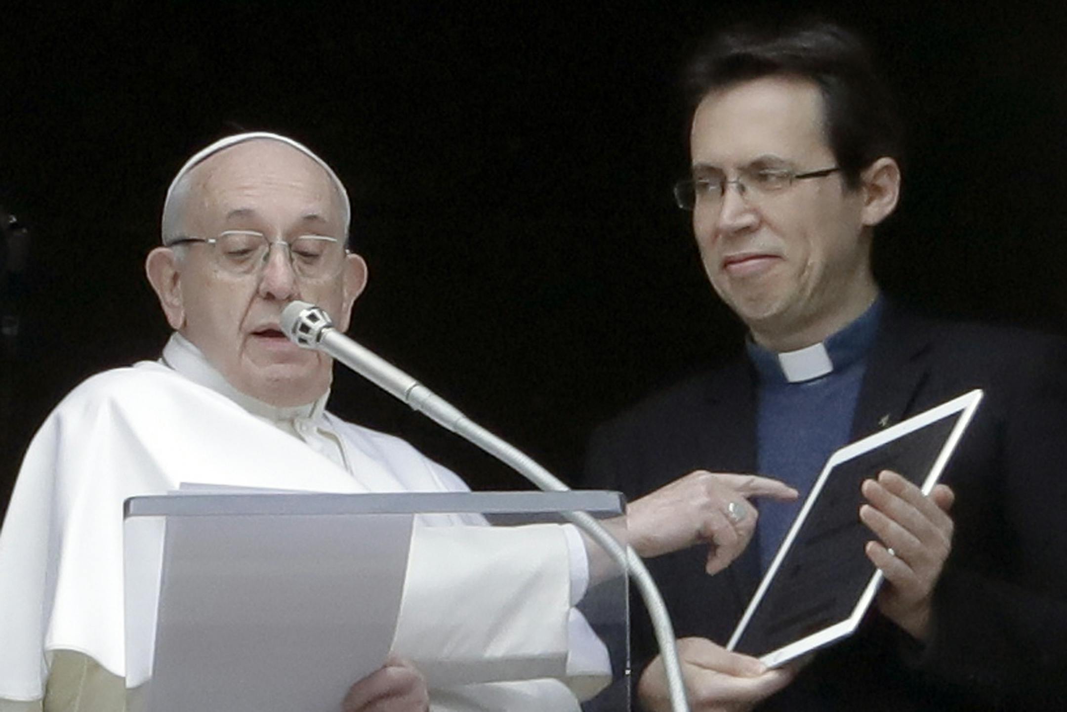 Pope Francis points at a tablet as he unveils his own user profile in Click To Pray, the official app of the Pope's Worldwide Prayer Network, during the Angelus noon prayer he recited from the window of his studio overlooking St. Peter's Square, at the Vatican, Sunday, Jan. 20, 2019. Click To Pray is the official prayer platform for World Youth Day 2019, that Francis will attend in Panama January 22-27, 2019. (AP Photo/Andrew Medichini) ORG XMIT: AJM105