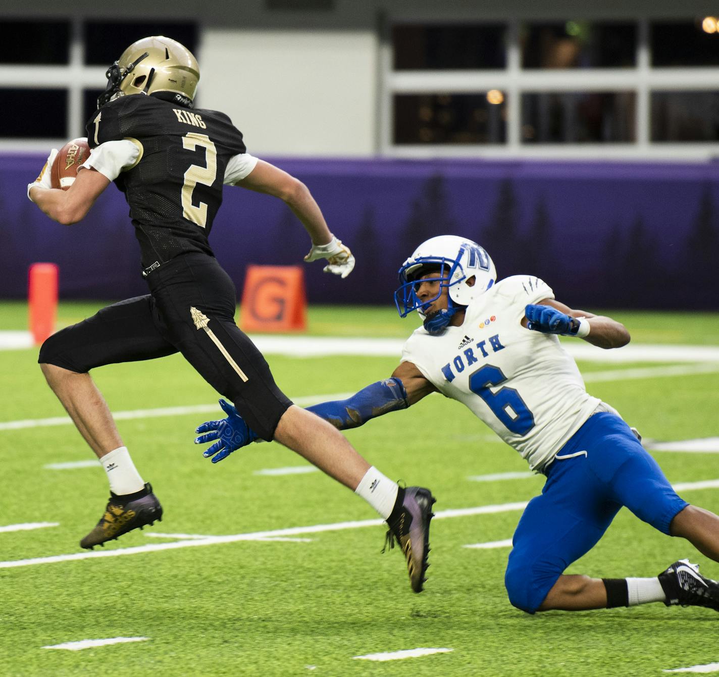 Caledonia wide receiver Elijah King, 2, evades a tackle from Minneapolis North&#xd5;s Elisha Jackson Jr, 6, during the first half of the Class AA championship at Prep Bowl XXXVIII at U.S. Bank Stadium on Friday, November 29, 2019. Caledonia is leading Minneapolis North 20-0 at the half.