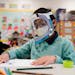A student wears a mask and face shield in a 4th grade class amid the COVID-19 pandemic at Washington Elementary School on Jan. 12, 2022, in Lynwood, C