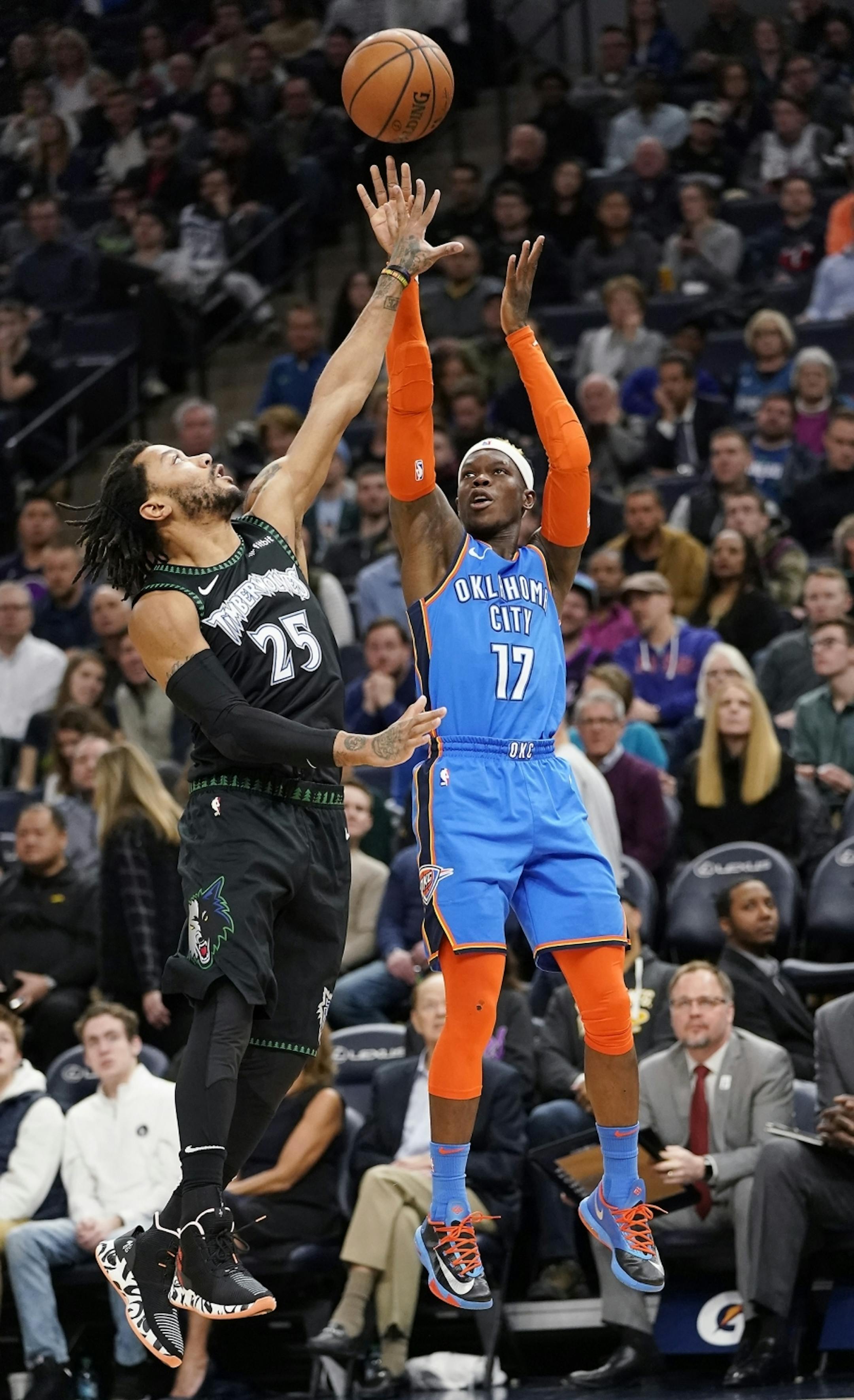 Oklahoma City Thunder guard Dennis Schroder (17) shoots as Minnesota Timberwolves guard Derrick Rose (25) defends during the second half.
