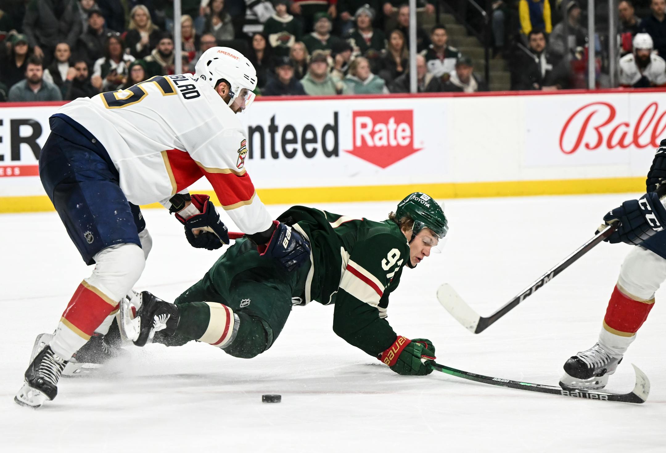 Minnesota Wild left wing Kirill Kaprizov (97) is knocked from behind onto to the ice by Florida Panthers defenseman Aaron Ekblad (5), leading to a scuffle, during the third period.