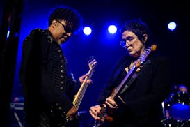 Bassist Mark “Brownmark” Brown and guitarist Wendy Melvoin perform with The Revolution Friday.