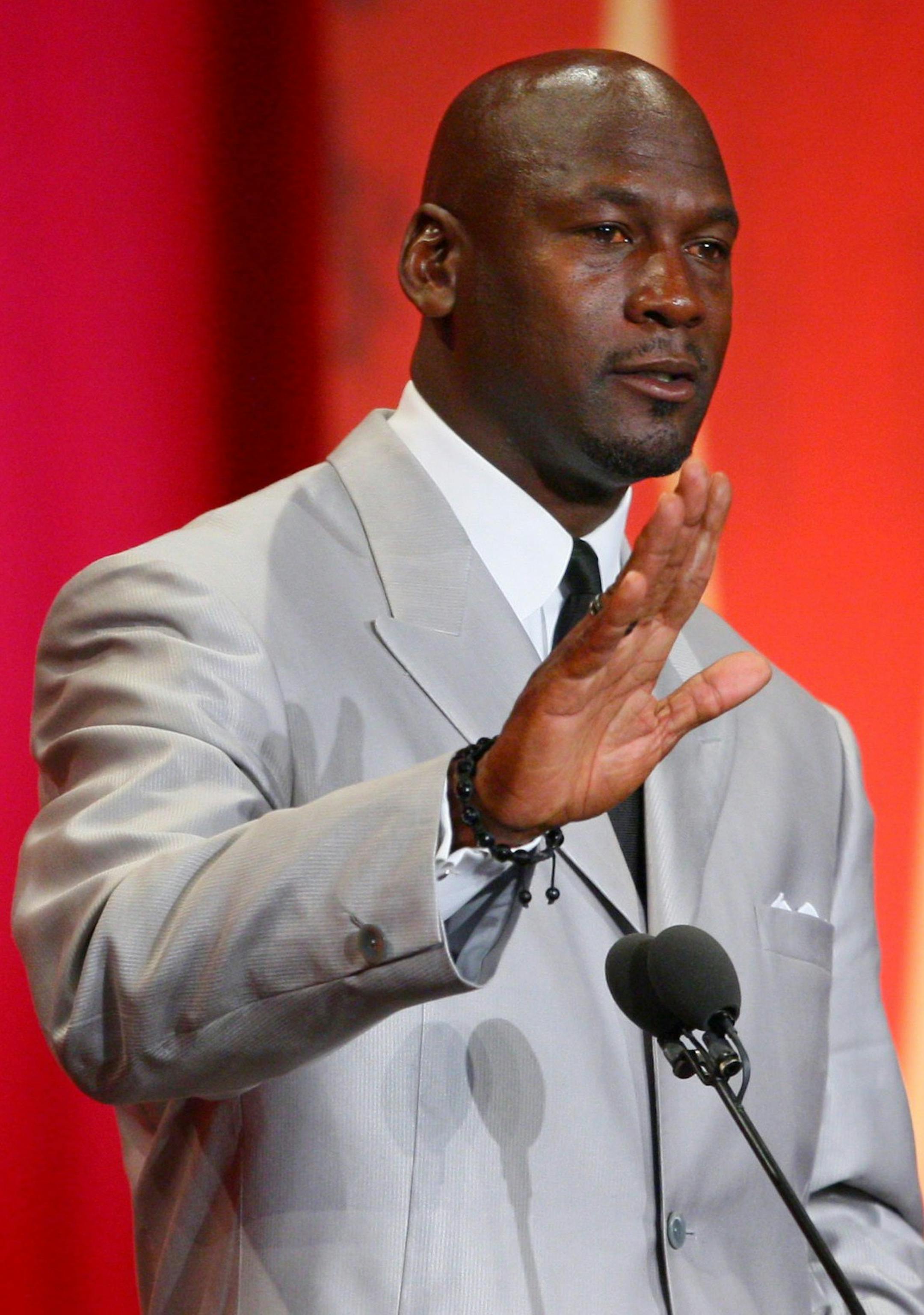 Former Chicago Bulls and Washington Wizards guard Michael Jordan waves he finishes his address before leaving the stage during his enshrinement ceremony into the Naismith Basketball Hall of Fame in Springfield, Mass., Friday, Sept. 11, 2009. (AP Photo/Stephan Savoia)