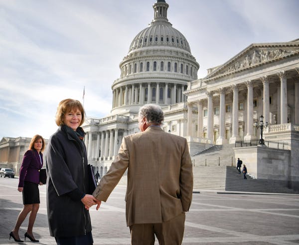 Holding hands with her husband Archie, Senator Tina Smith walked toward the U.S. Capitol building in the morning sun for her swearing in ceremony. ] G