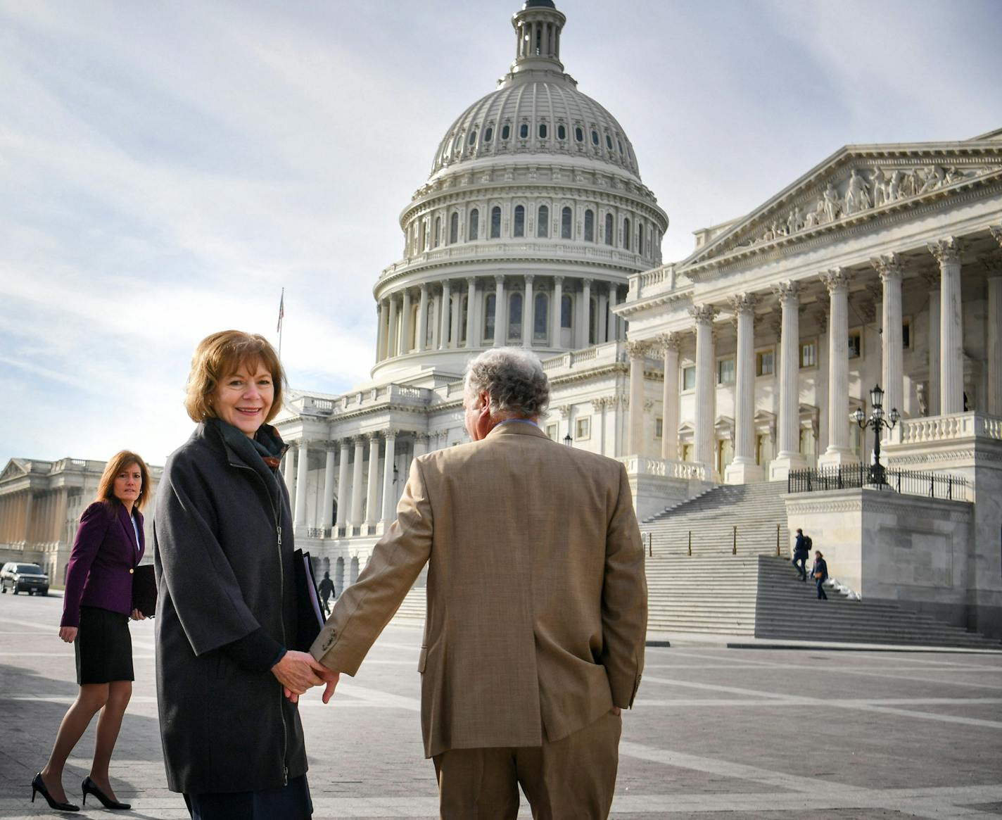 Holding hands with her husband Archie, Senator Tina Smith walked toward the U.S. Capitol building in the morning sun for her swearing in ceremony. ] GLEN STUBBE &#xd4; glen.stubbe@startribune.com Wednesday, January 3, 2018 Tina Smith is sworn in as Minnesota's junior U.S. senator, replacing Al Franken the day after he resigns. ORG XMIT: MIN1801031354430667