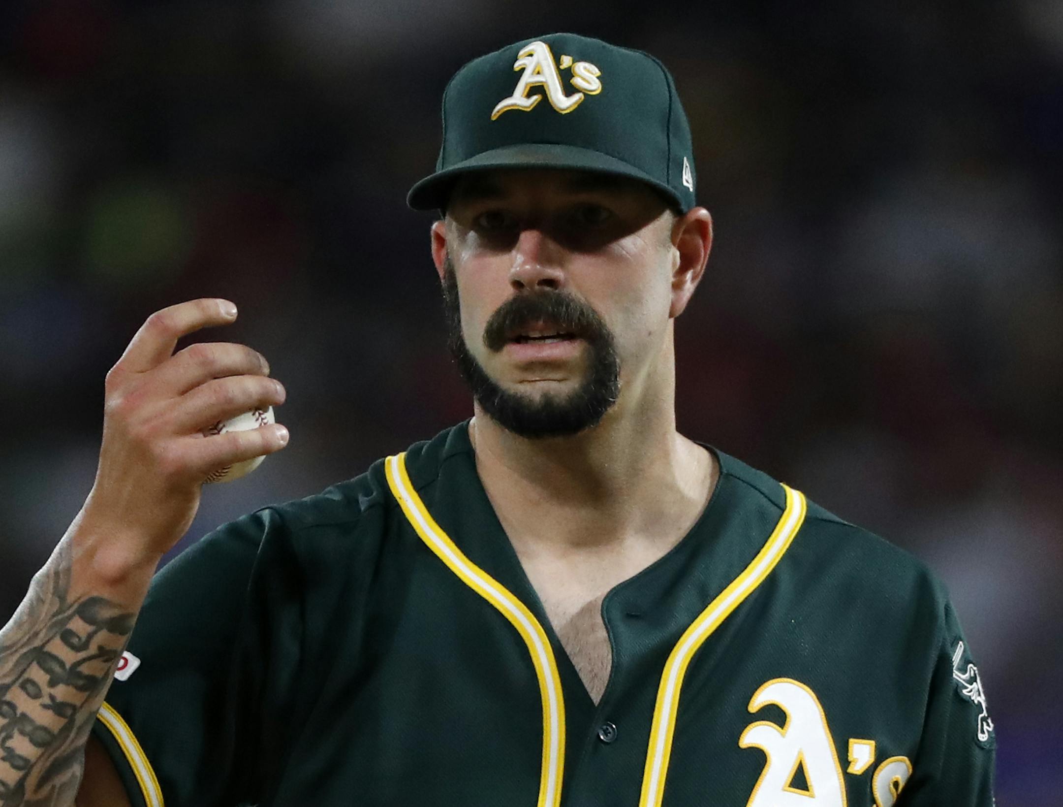Oakland Athletics starting pitcher Mike Fiers looks at manager Bob Melvin and staff walking out to the mound to pull him in the second inning of a baseball game against the Texas Rangers in Arlington, Texas, Saturday, Sept. 14, 2019. Fiers left the game with an unknown injury. (AP Photo/Tony Gutierrez) ORG XMIT: ARL201