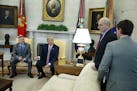 President Donald Trump speaks with White House Chief of Staff John Kelly, second from right, and White House deputy press secretary Hogan Gidley, righ