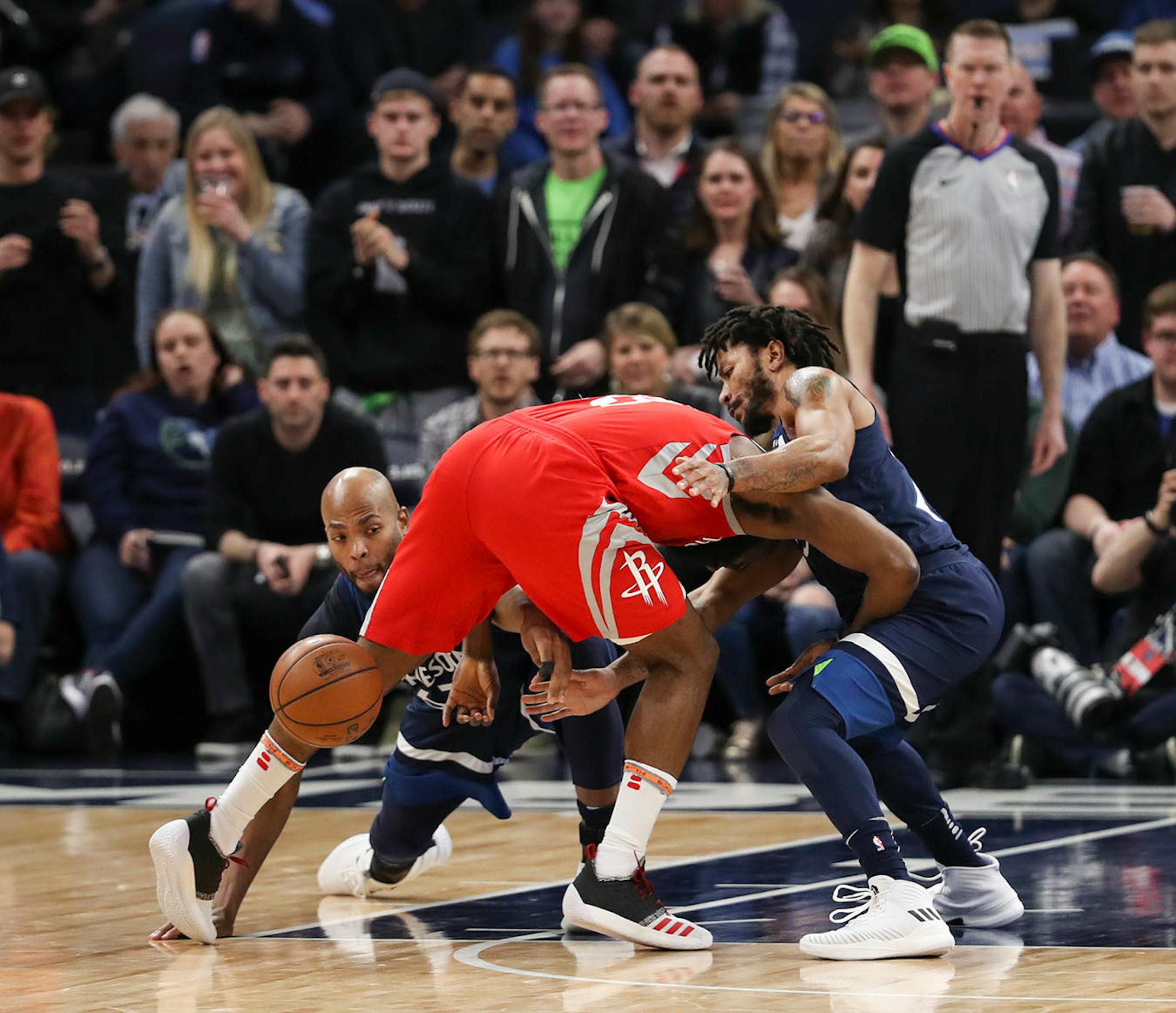 Minnesota Timberwolves forward Taj Gibson, left, and guard Derrick Rose stripped the ball from Houston Rockets guard James Harden in the fourth quarter.