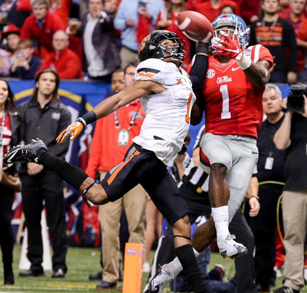 January 01, 2016: Ole Miss Rebels wide receiver Laquon Treadwell (1) catches a touchdown against Oklahoma State Cowboys cornerback Kevin Peterson (1) 
