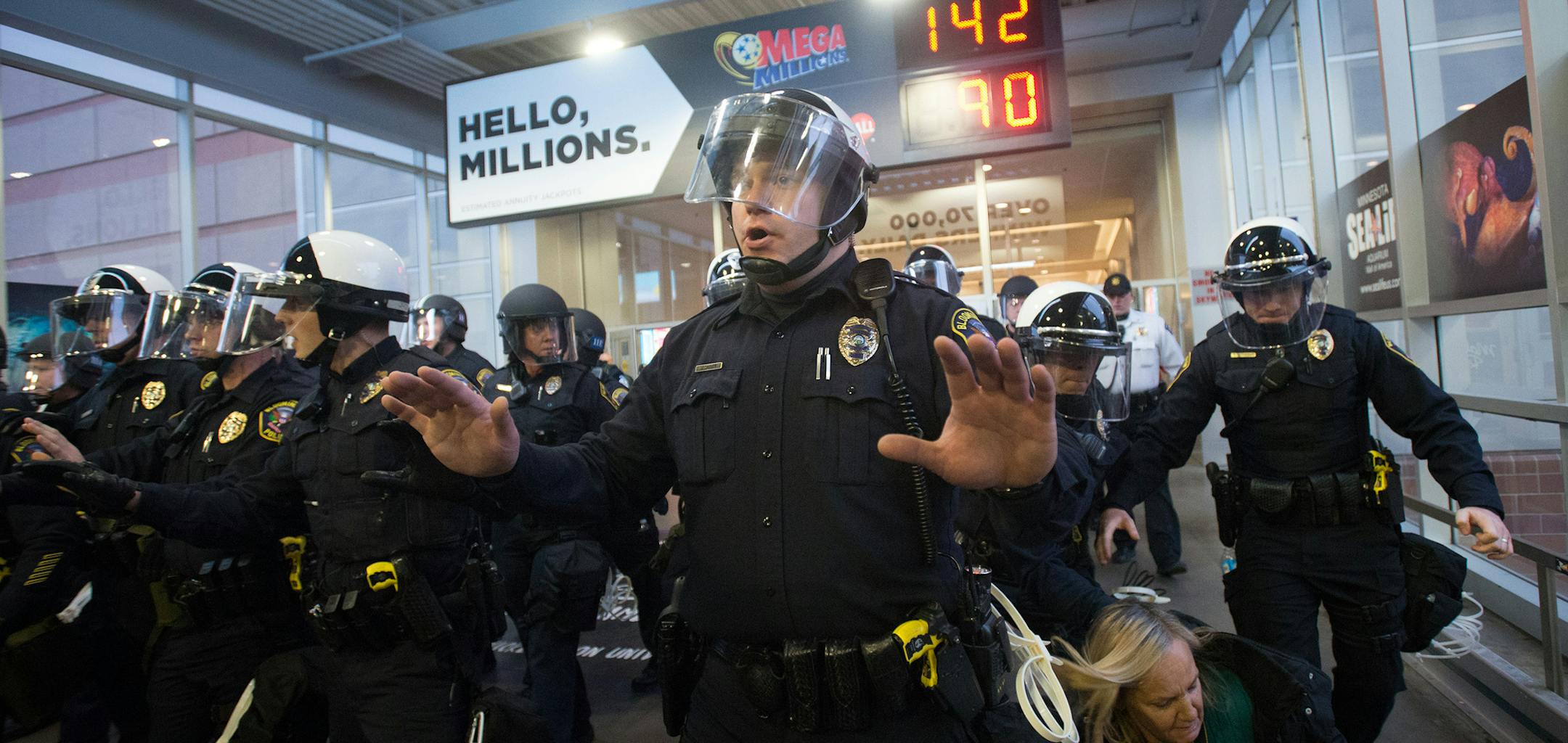 Police in riot gear chant "move" as they begin marching on protestors that remained on a second-floor bridge linking the Mall of America to the east parking garage in Bloomington, Minn., on Saturday, Dec. 20, 2014, during a demonstration to focus attention on perceived nationwide race-based police misconduct. (Aaron Lavinsky/Minneapolis Star Tribune/TNS)