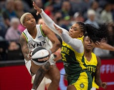 Lynx guard Courtney Williams drives around Storm guard Victoria Vivians (35) in the first quarter Sunday night at Target Center.