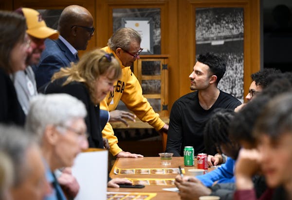 Gophers basketball player Dawson Garcia talks with booster Steve Erban of Stillwater at a Dinkytown Athletes event in March at Williams Arena.