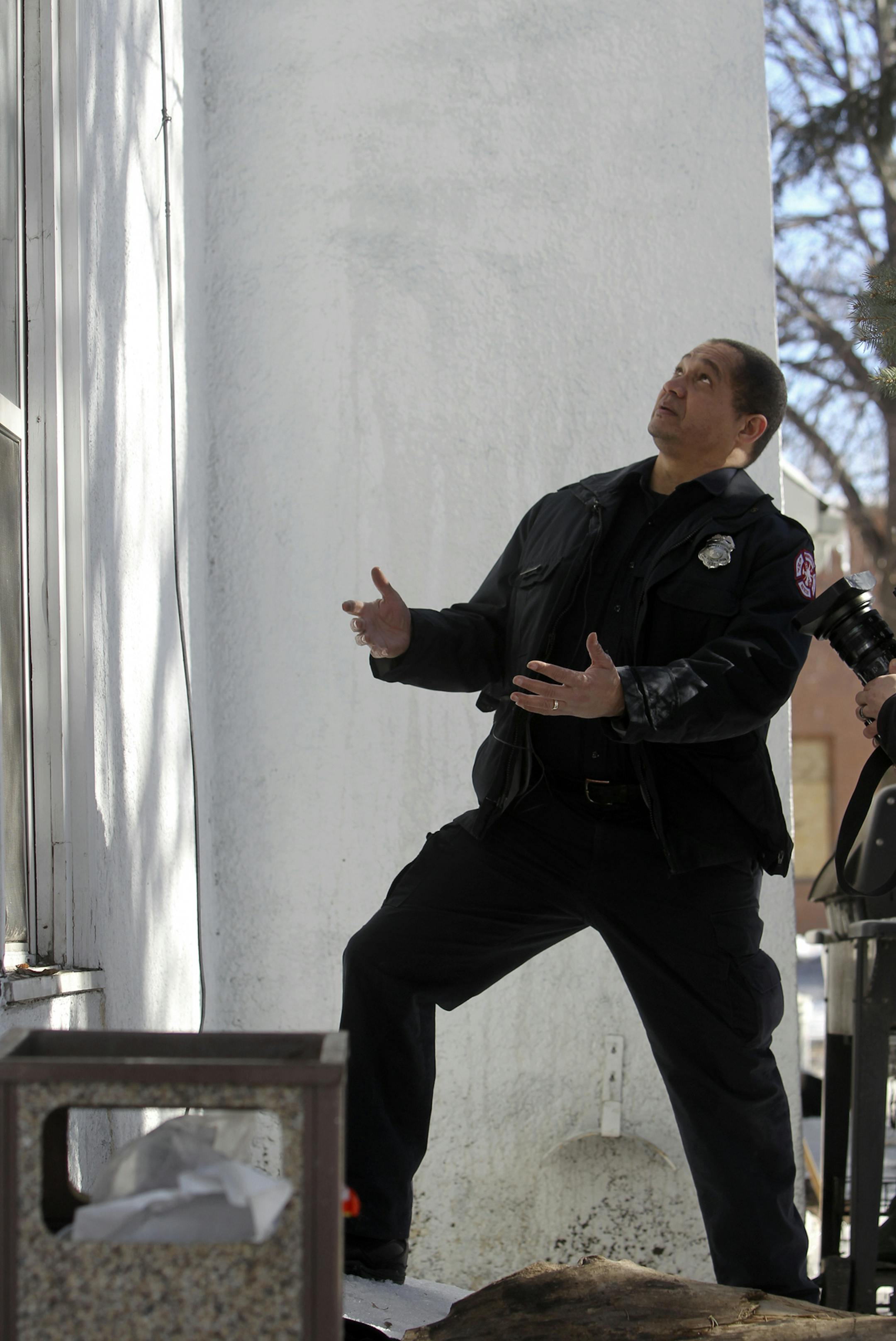 Minneapolis Fire Department driver Robert Martin, one of the first on the scene of an early morning fire at an 4425 Aldrich Ave. N. apartment building that left nine injured, demonstrated for a tv news crew how he caught a four-year old child dropped down to safety from a second story window Saturday, March 2, 2013, in Minneapolis, MN.] (DAVID JOLES/STARTRIBUNE) Followup on early morning northside apartment fire where several residents fled by jumping from windows and nine were injured.**Robert