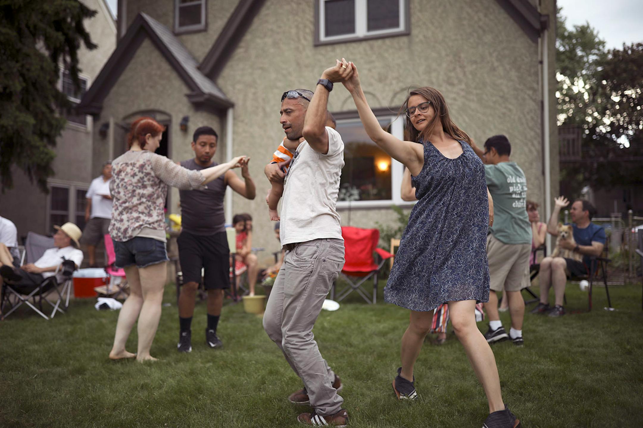 A crowd of friends, including Maria Schwedhelm and Sandro Rios, holding their son, Ilan, danced Afro Cuban style on Stephanie Owen's front yard on 28th Ave. S. Monday afternoon. Earlier in the day they had been across the street at Lake Hiawatha Park, but when rain threatened they moved the party to the front yard. "The first of many Memorial Day parties," Owen said.