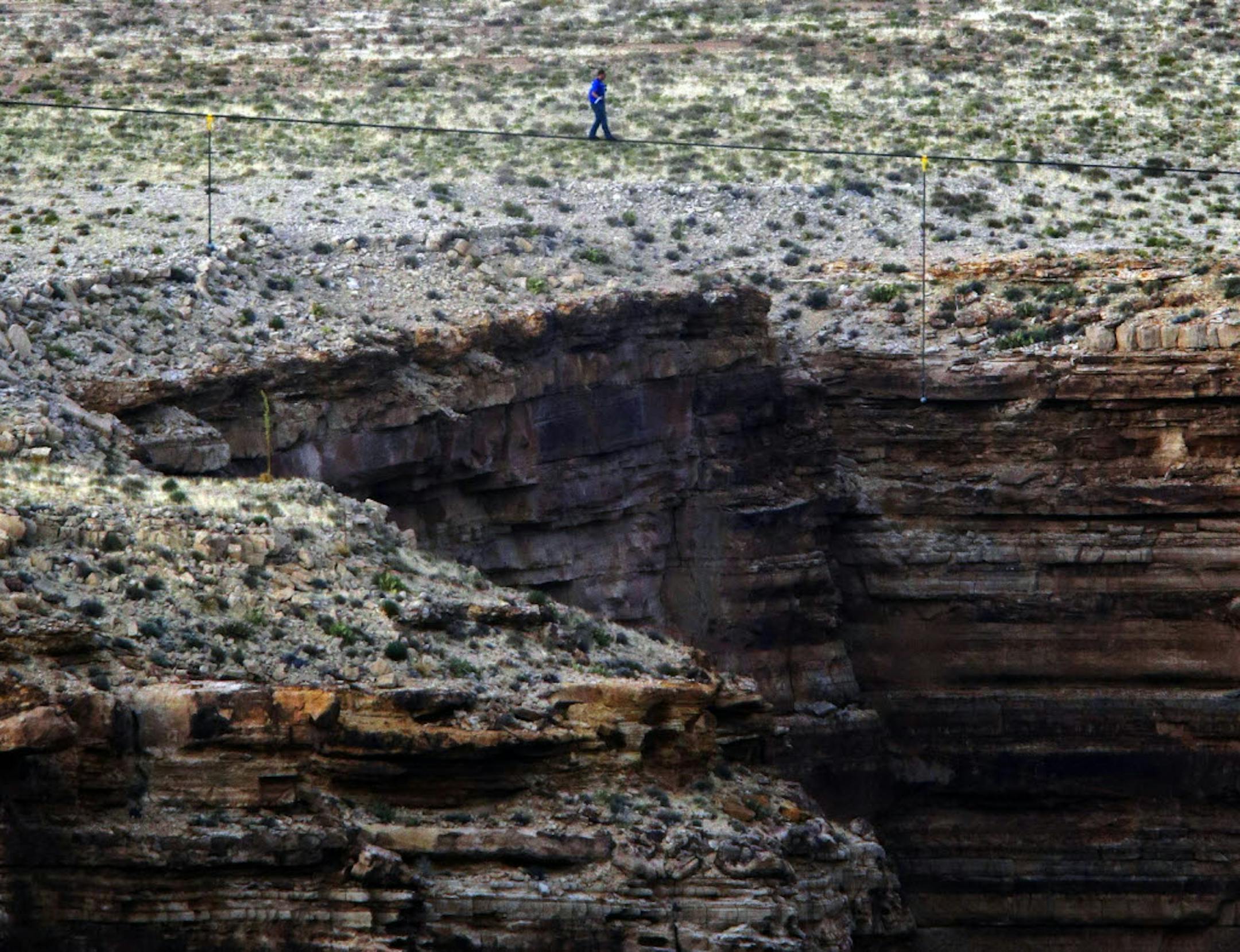 Daredevil Nik Wallenda crosses a tightrope 1,500 feet above the Little Colorado River Gorge, Ariz., on Sunday.