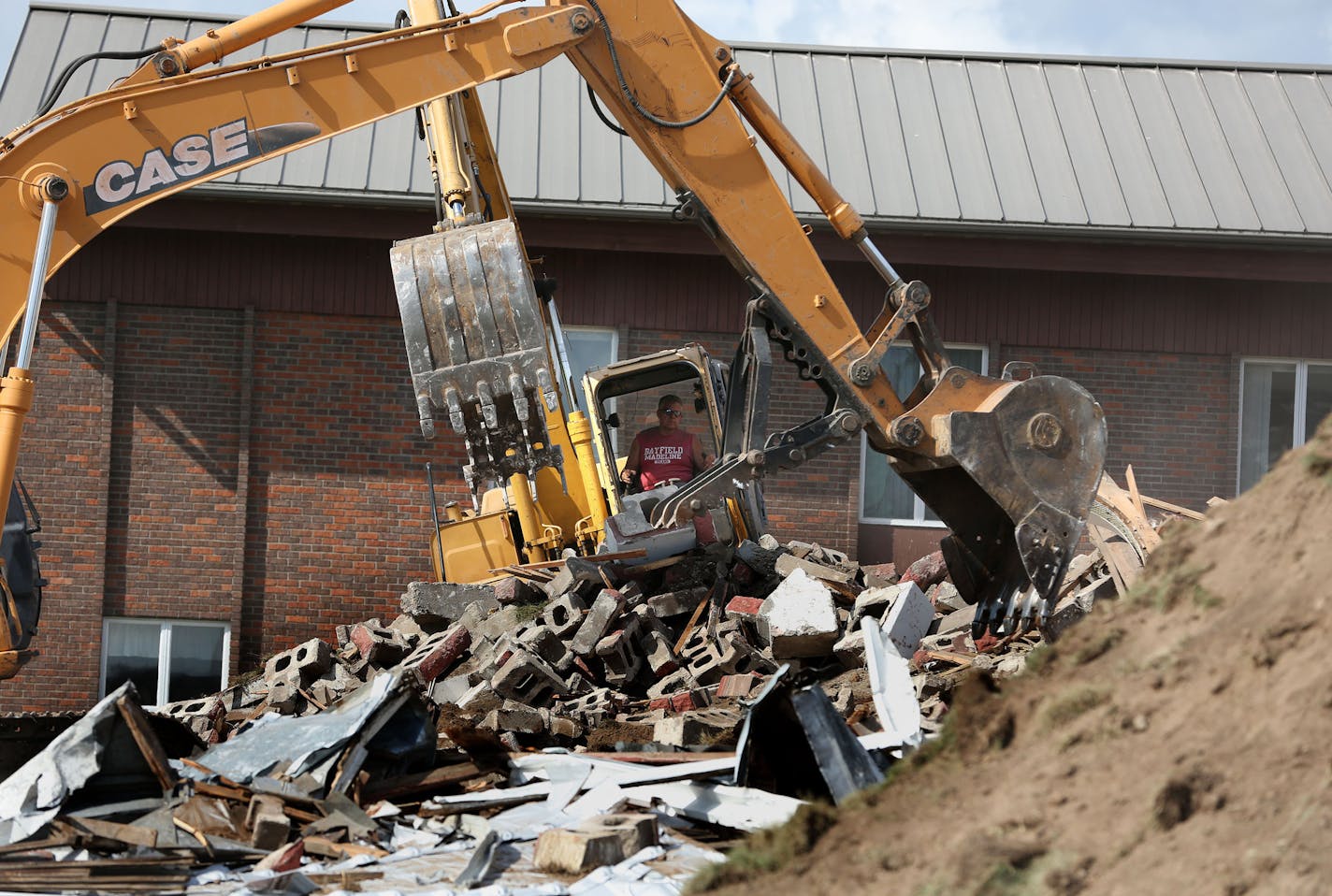 What was left of the Peace Lutheran Church as they continued with demolition. ] (KYNDELL HARKNESS/STAR TRIBUNE) kyndell.harkness@startribune.com During the demolition of Peace Lutheran Church in Baldwin Wis. Friday, August, 15, 2014. Plans for solving some of the issues that the109 year old church had had been in the works since 2005 said Pastor John Anderson, who had been there for 22 years. He said that the membership had voted to stay together and couldn't afford the expense of saving the str