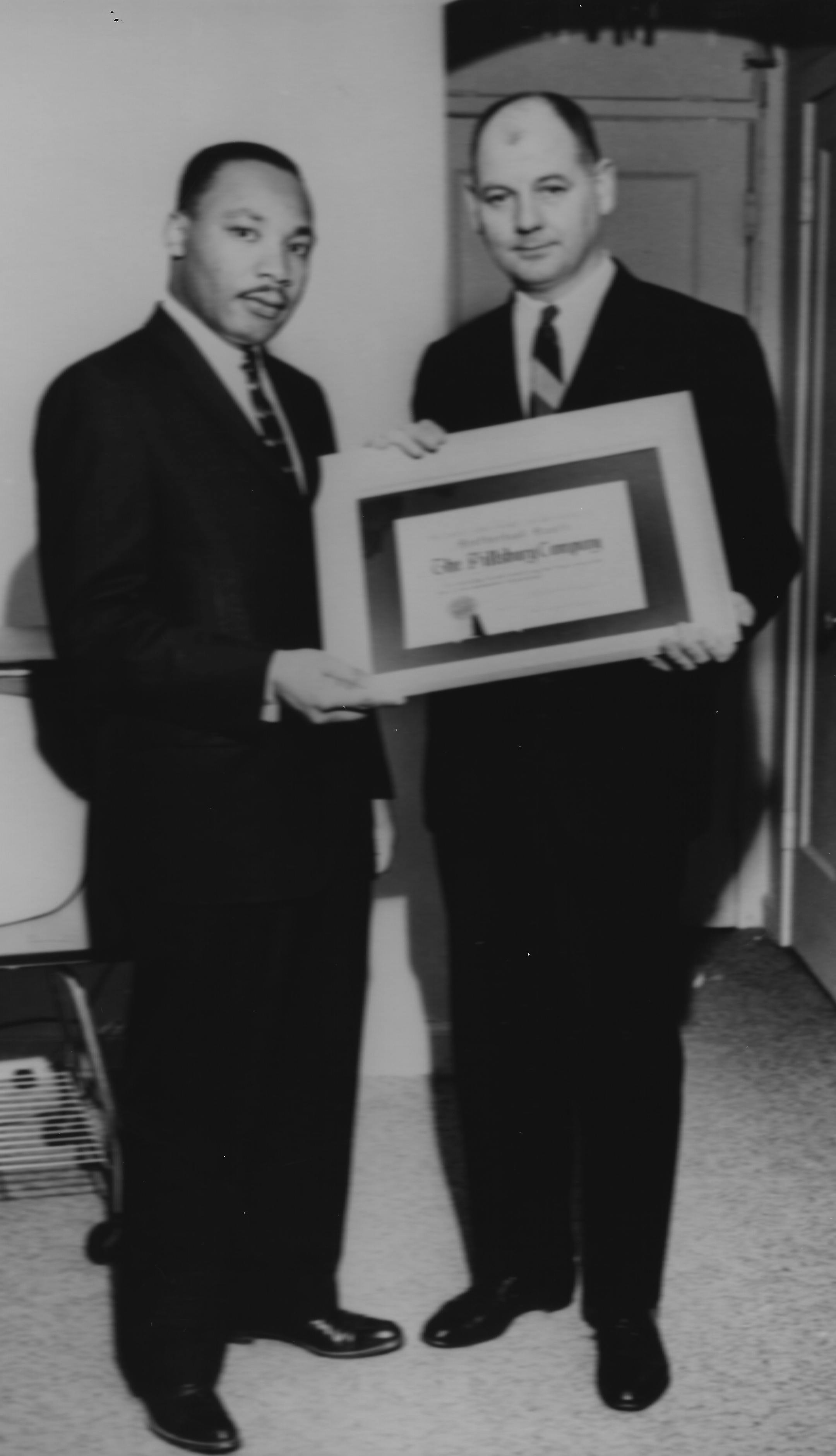 Minneapolis ad man Bill Powell receives an award from Martin Luther King Jr. in 1961.