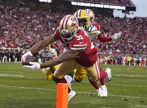 San Francisco running back Raheem Mostert scores in front of Green Bay free safety Darnell Savage during the first half of the NFC Championship Game