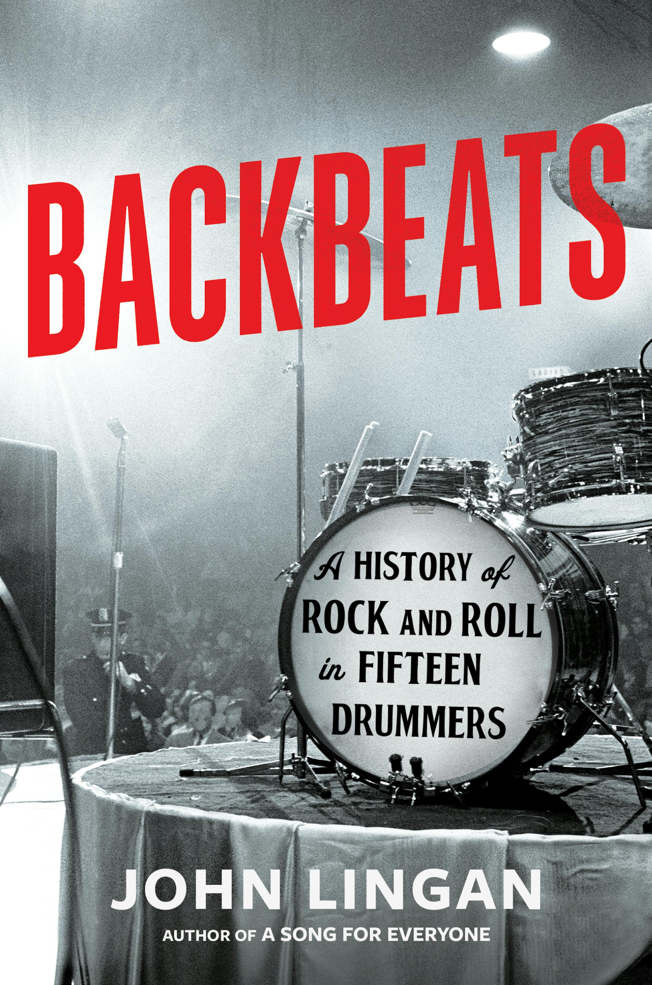 cover of Backbeats is a black and white photo of a drum set on a stage, with a dim crowd in the background